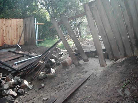 1978 Ford Bronco - A construction site shows a damaged wooden fence and scattered building materials.