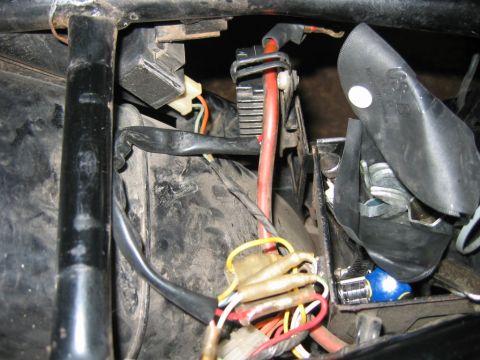 1985 Ford LTD Crown Victoria - Close-up view of motorcycle electrical components, including wiring and a regulator rectifier.