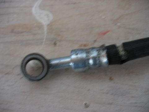 1985 Ford LTD Crown Victoria - A close-up view of a brake hose, a critical component for vehicle safety.