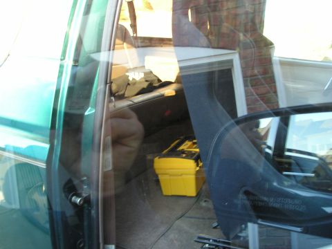 1996 Ford Bronco - View of the interior from the driver's side, showing a yellow toolbox and the rear seating area.