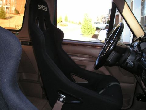 1996 Ford Bronco - Black Sparco racing seats are visible inside the vehicle's cabin.