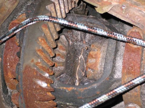 1989 Ford F-150 - Rusty differential gears are visible in this close-up view, partially obscured by a braided cable.
