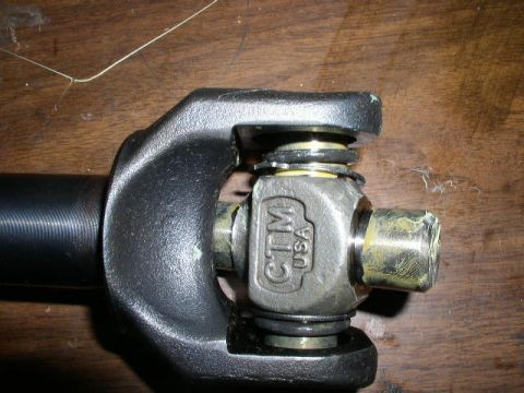1978 Ford Bronco - Close-up of a driveshaft U-joint with visible branding and signs of use.