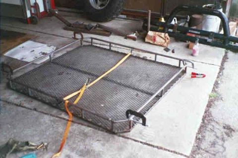 1994 Ford Bronco - A metal cargo carrier rack is shown secured with a yellow strap.