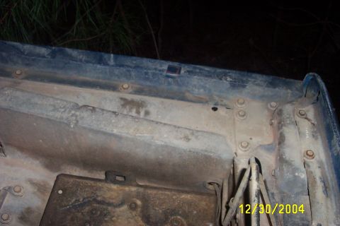 1979 Ford F-150 - Close-up view of the underside of a blue vehicle component, showing structural details and mounting points.
