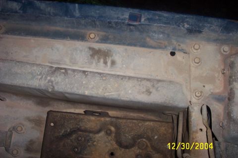1979 Ford F-150 - Close-up view of rusted metal frame components and fasteners.