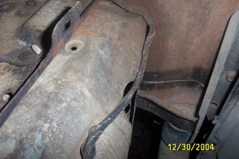 1979 Ford F-150 - Undercarriage view of rusted metal components and wiring, with a date stamp of 12/30/2004.