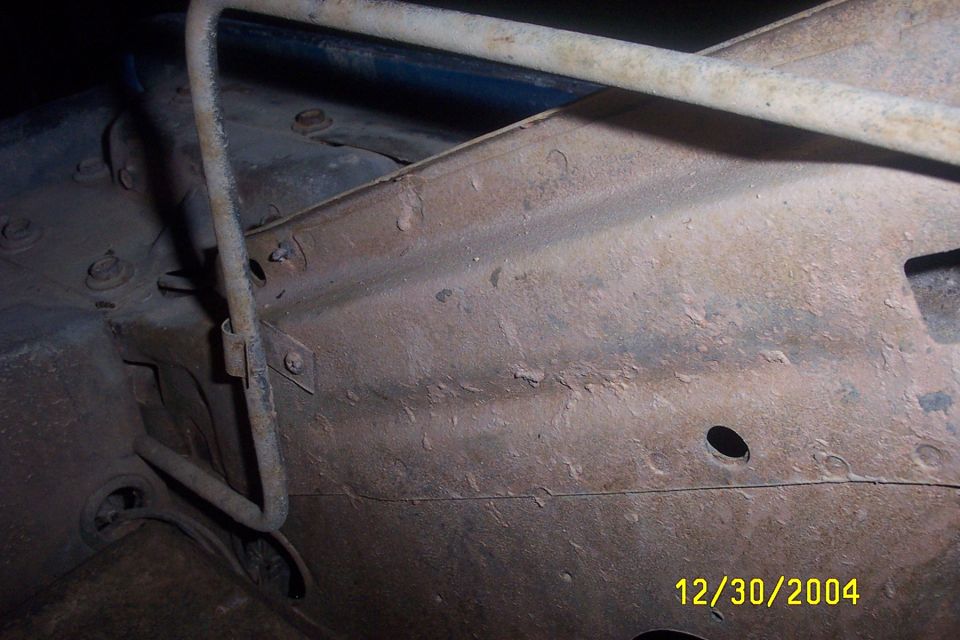 rusted metal frame with some pipes and bolts