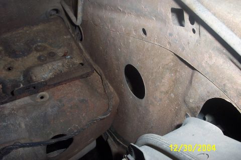 1979 Ford F-150 - This image shows the heavily rusted frame and engine bay of a vehicle, dated December 30, 2004.