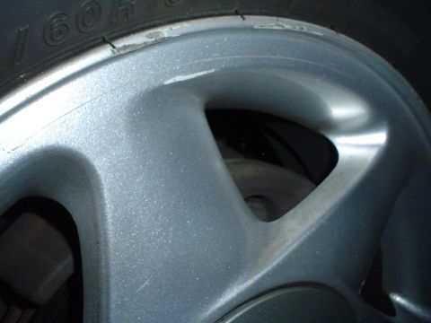 1993 Ford Taurus - Close-up of a silver alloy wheel and tire, with visible tire size information.