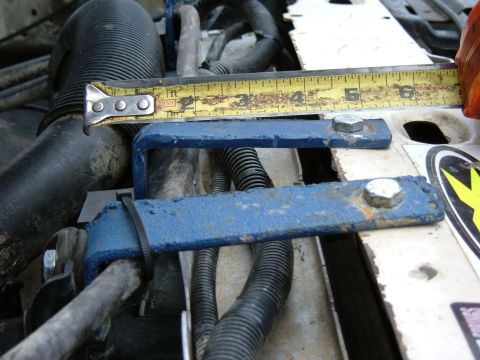 1985 Ford F-150 - Close-up of engine bay modifications with a tape measure indicating dimensions.