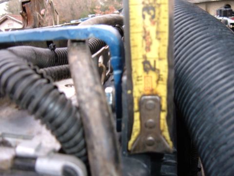 1985 Ford F-150 - A close-up view of an engine bay shows a yellow measuring tape, indicating a measurement of about 2.5 inches.