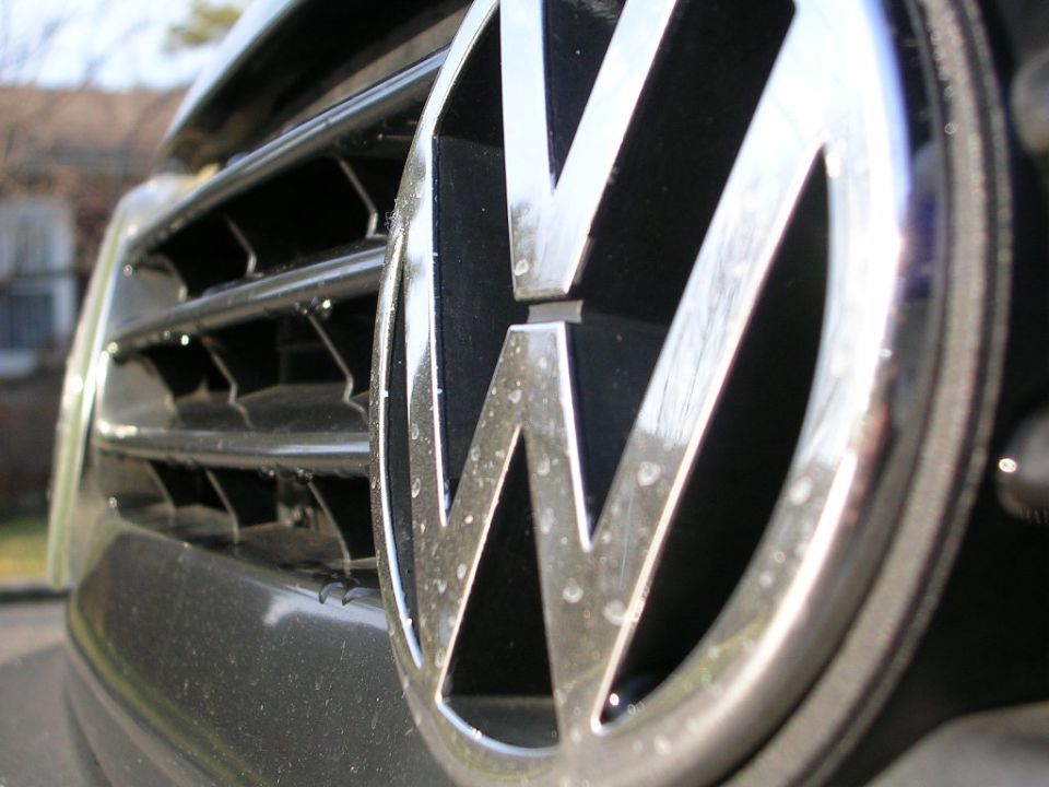 Close-up of a Volkswagen emblem on a car's front grille