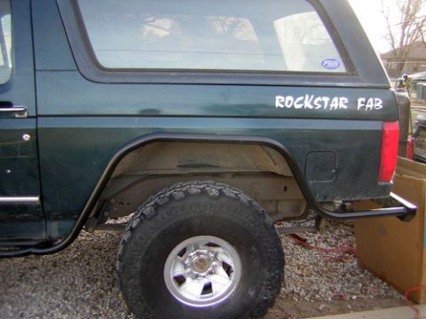 1995 Ford Bronco - Rear quarter panel and tire of a 1995 Ford Bronco with a "ROCKSTAR FAB" decal on the body.