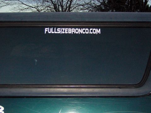 1995 Ford Bronco - A sticker on a vehicle's window advertises a website related to Broncos.
