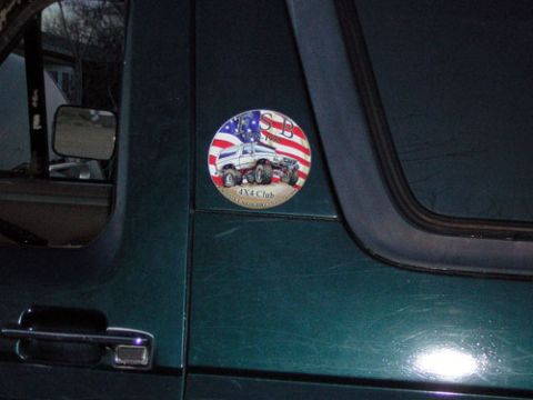 1995 Ford Bronco - A circular sticker with 'SB 1990 4X4 Club' is affixed to the side of a dark green vehicle.