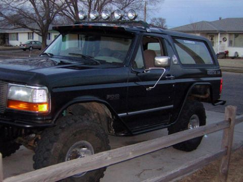 1995 Ford Bronco - This 1995 Ford Bronco features large off-road tires and a light bar on the roof.