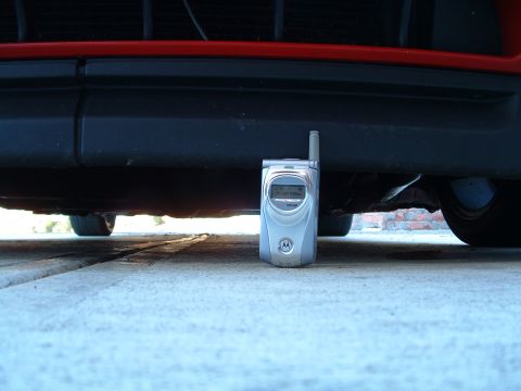 1994 Volkswagen Jetta - Cell phone for scale under the front bumper of a car.