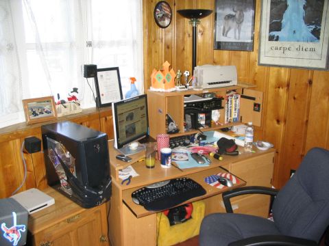 1986 Ford Bronco - A cluttered desk area with a computer, monitor, and office supplies is visible.