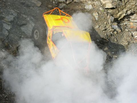 1978 Ford Bronco - This off-road vehicle navigates a challenging rocky path, enveloped in a cloud of smoke.