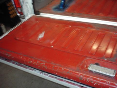 1978 Ford Bronco - The tailgate of a 1978 Ford Bronco shows some wear and tear, with a chrome handle.