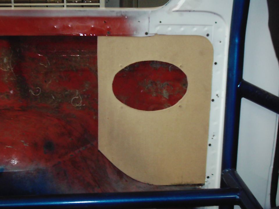 Interior panel with oval speaker cutout, showing red interior
