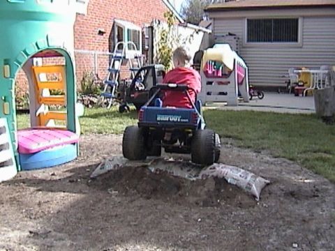 1985 Ford F-150 - Backyard scene with a child playing in a toy truck.