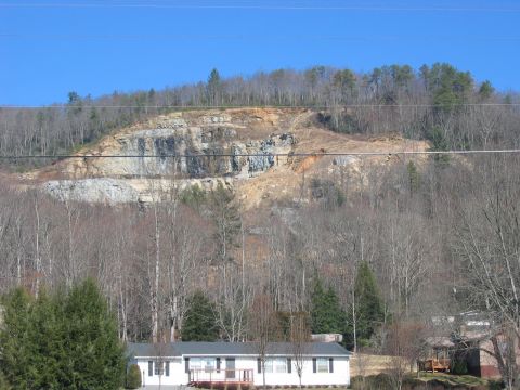 1985 Ford Crown Victoria LTD - A mobile home sits in front of a large quarry under a clear blue sky.
