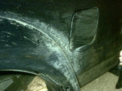 1995 Ford Bronco - Close-up of the rear wheel well of a 1995 Ford Bronco, showing wear and tear.