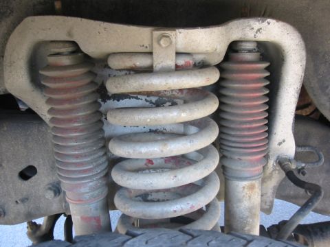 1992 Ford Bronco - The vehicle's front suspension system, coil springs and shock absorbers, is shown in detail.