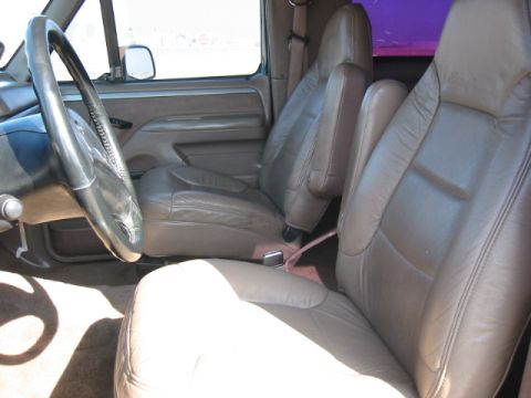 1992 Ford Bronco - Interior view of a 1992 Ford Bronco, showing the driver's seat, passenger seat, and steering wheel.