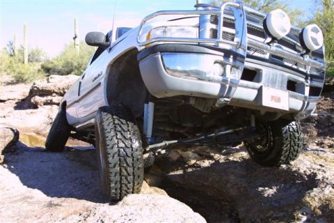 1994 Ford Bronco - This Dodge Ram is tackling a challenging rocky trail, showing off its off-road capabilities.