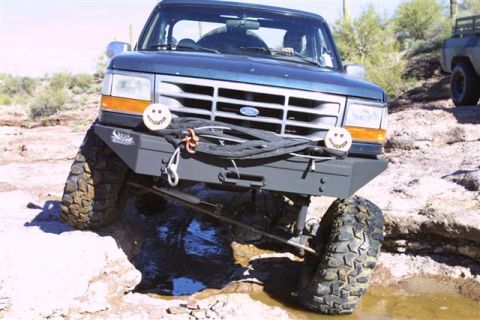1994 Ford Bronco - This Ford Bronco is navigating rocky terrain, with another vehicle visible in the background.