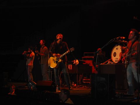 1989 Ford Bronco - A band plays music on stage in front of an audience.