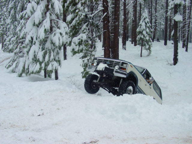 Ford Bronco stuck in deep snow, front wheel in air