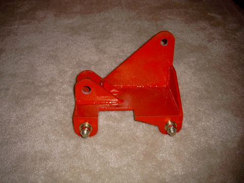 1991 Ford Bronco - This red traction bar bracket is shown on a carpeted surface. The registry claims it is for a 1991 Ford Bronco, but this cannot be verified…