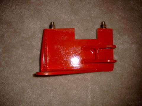 1991 Ford Bronco - A red metal bracket, likely a vehicle part, is shown against a textured background.