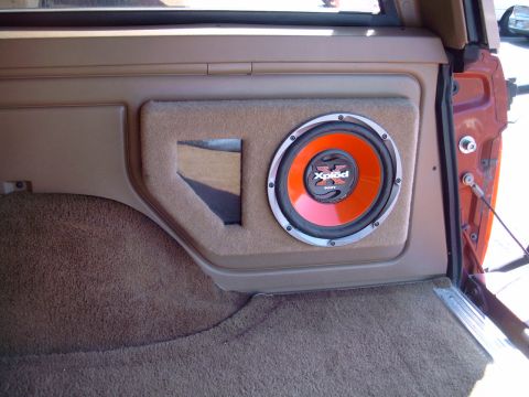 1991 Ford Bronco - A custom-built subwoofer enclosure is integrated into the interior panel of a vehicle.