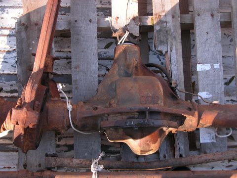 1990 Ford Bronco - A heavily rusted differential housing, possibly from a Ford Bronco, is shown with visible stamping.
