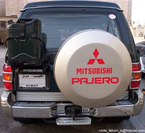 2000 Mitsubishi Montero - Rear view of a 2000 Mitsubishi Montero, equipped with a spare tire cover and a jerry can.