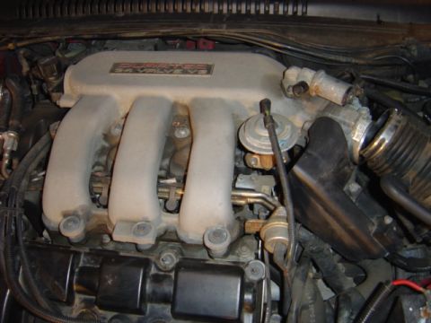 1998 Ford Taurus - The image shows a close-up view of a V6 engine's intake manifold, with visible text indicating "3.0L 24 VALVE".