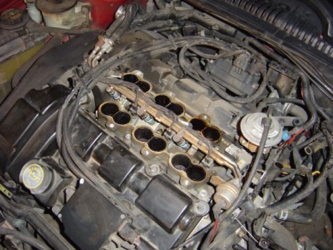 1998 Ford Taurus - Close-up view of an engine with parts removed, showing the fuel injectors and intake manifold.