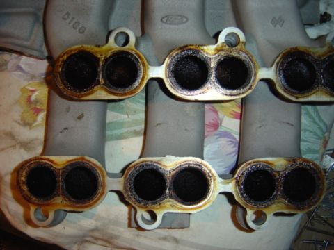 1998 Ford Taurus - Intake manifold part with carbon buildup in the ports.