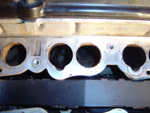 1998 Ford Taurus - Close-up of an engine intake manifold, showing internal ports and metal casting details.