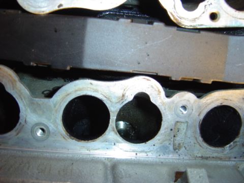 1998 Ford Taurus - Close-up view of an engine intake manifold showing carbon deposits within the ports.
