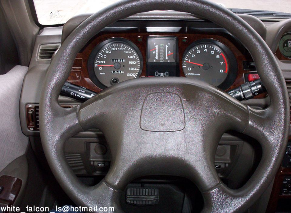 SUV instrument cluster and steering wheel showing speedometer and tachometer