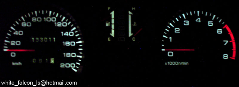 Night-lit gauge cluster: speedometer, fuel/temp gauges, and tachometer.