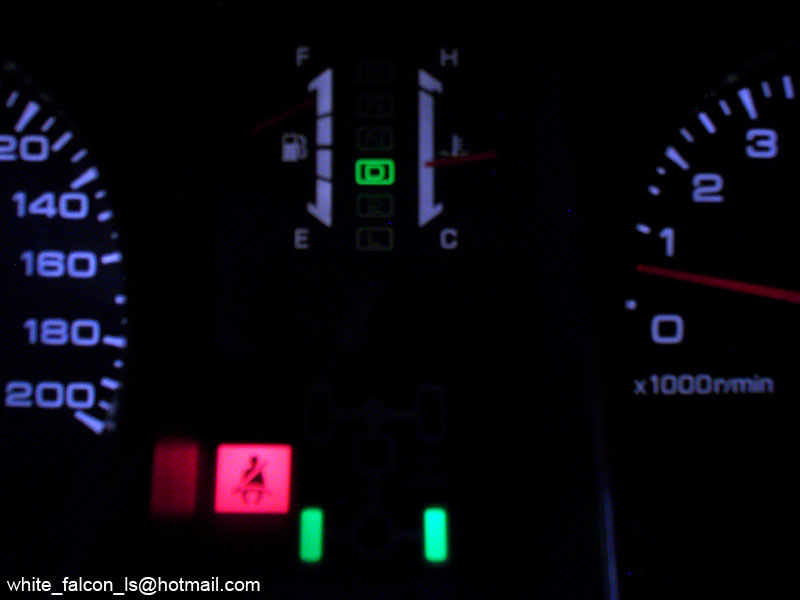 Illuminated gauge cluster with speedometer, tachometer, and green 4WD indicator lights