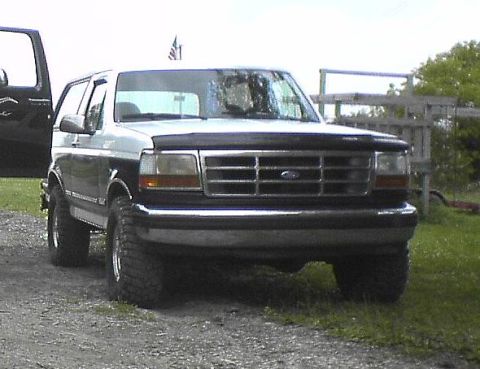 1995 Ford Bronco - Front view of a two-tone 1995 Ford Bronco with aftermarket wheels.