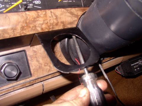 1986 Ford Bronco - Inside screwing the home made gauge holder into the same spot the old Voltmeter used to occupy,